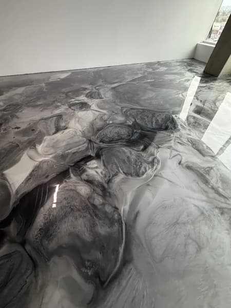 Metallic epoxy coating with deep grey tones on a commercial floor