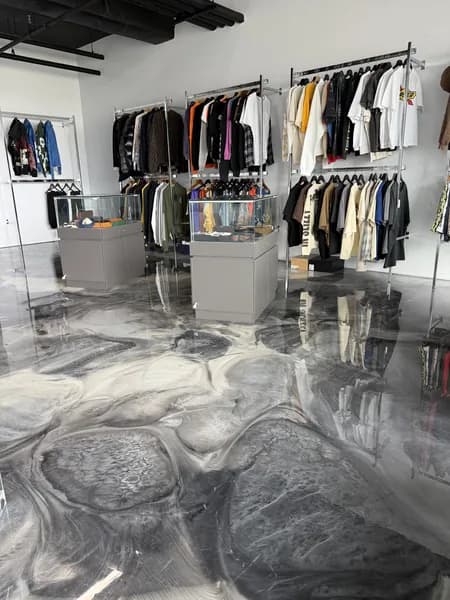 Metallic epoxy floor with blue-silver swirl pattern by Go2Epoxy