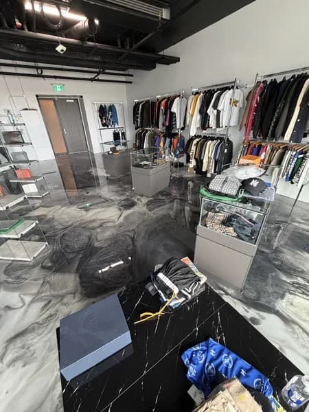 Custom metallic epoxy showroom floor with mirror-like reflective finish