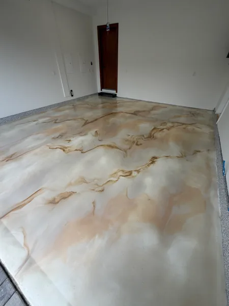 Close-up of white and gold metallic epoxy veining in a Surrey garage