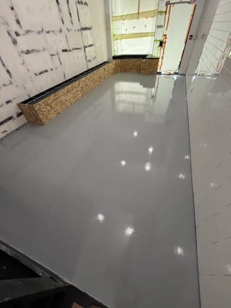 High-gloss grey solid epoxy floor in a Vancouver commercial unit under renovation