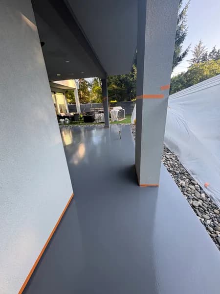 Grey solid epoxy patio with orange edge trim in Maple Ridge, BC