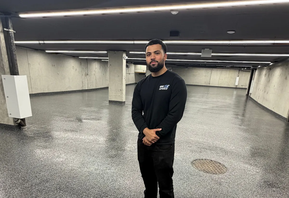 Go2Epoxy founder Ibrahim standing on a grey flake epoxy floor in a commercial parkade